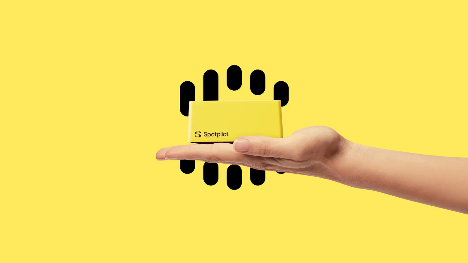Hand holding the yellow Spotpilot device against a yellow background with the Spotpilot symbol